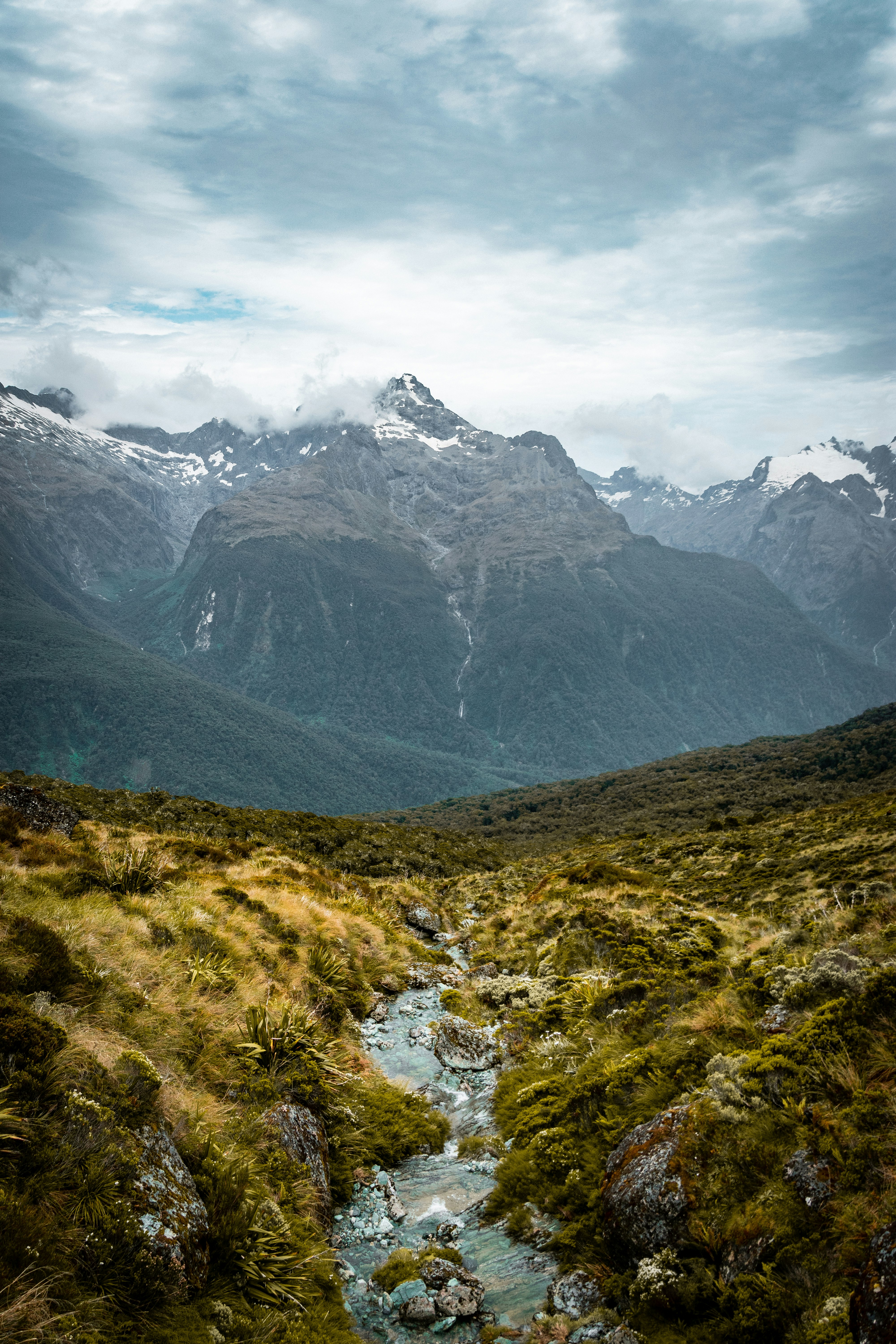 green grass field and mountains during daytime